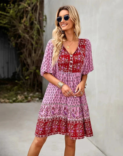 Pink - Light blue and mustard orange mixed floral print dress featuring a split v-neckline with ties, half puff sleeves, and a tiered skirt.