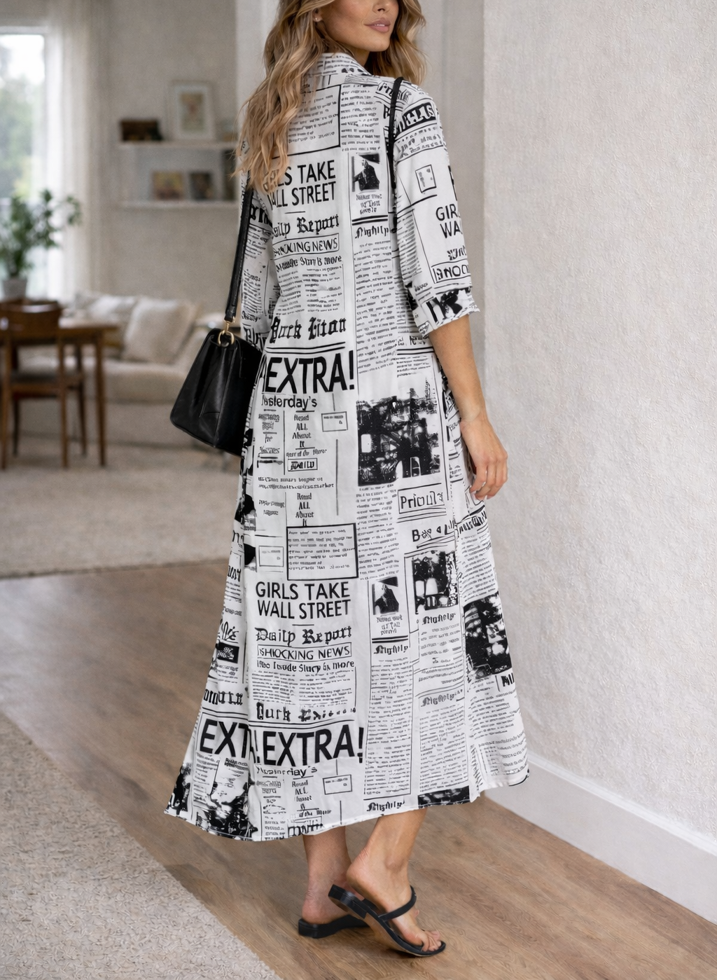 White - Woman wearing a black and white newspaper print maxi shirt dress with a collared neckline, button-down front, and rolled sleeves.