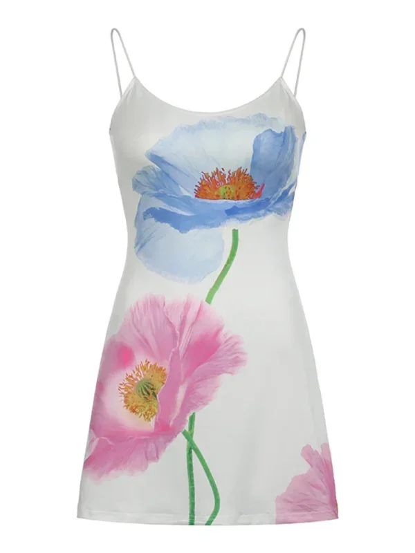 White - Woman wearing a white slip mini dress featuring a large-scale pink and blue painted floral print, styled with delicate spaghetti straps and a straight neckline.