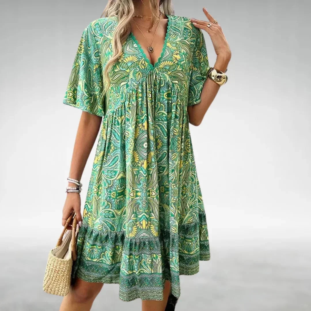 Green - Women's green and yellow intricate paisley print mini dress featuring a lace-trimmed V-neckline, flutter sleeves, and a tiered ruffled hem.