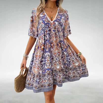 Blue - Women's green and yellow intricate paisley print mini dress featuring a lace-trimmed V-neckline, flutter sleeves, and a tiered ruffled hem.