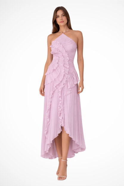 Purple - A woman wearing a sleeveless, light pink halter maxi dress made of pleated chiffon, featuring a cascading ruffle down the front and an asymmetrical high-low hemline.
