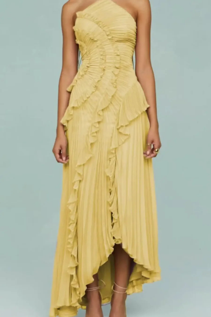 Purple - A woman wearing a sleeveless, light pink halter maxi dress made of pleated chiffon, featuring a cascading ruffle down the front and an asymmetrical high-low hemline.