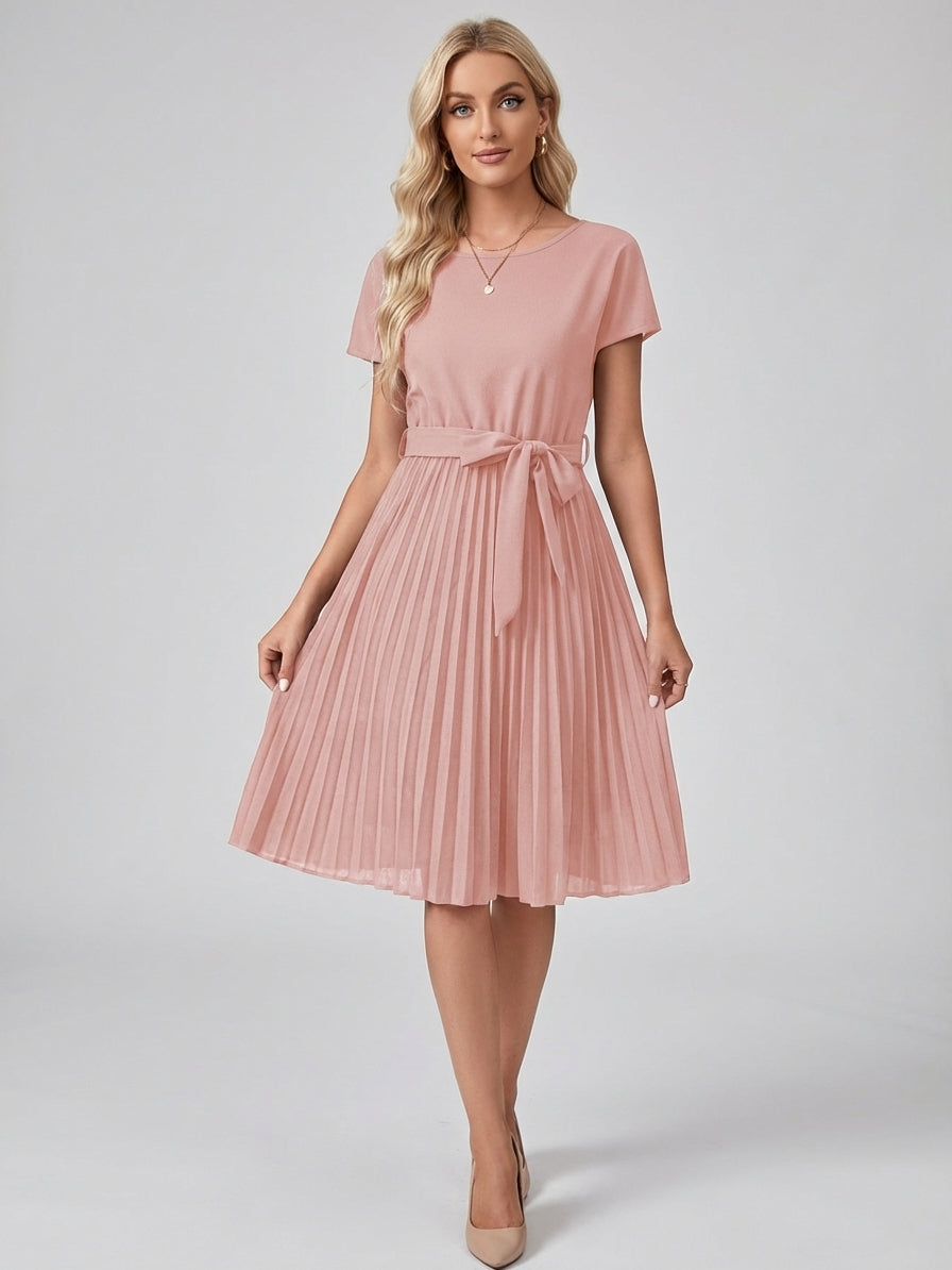 Pink - A woman wearing a short-sleeve, crew-neck burgundy midi dress with a belted waist and a pleated accordion skirt, holding a black clutch.