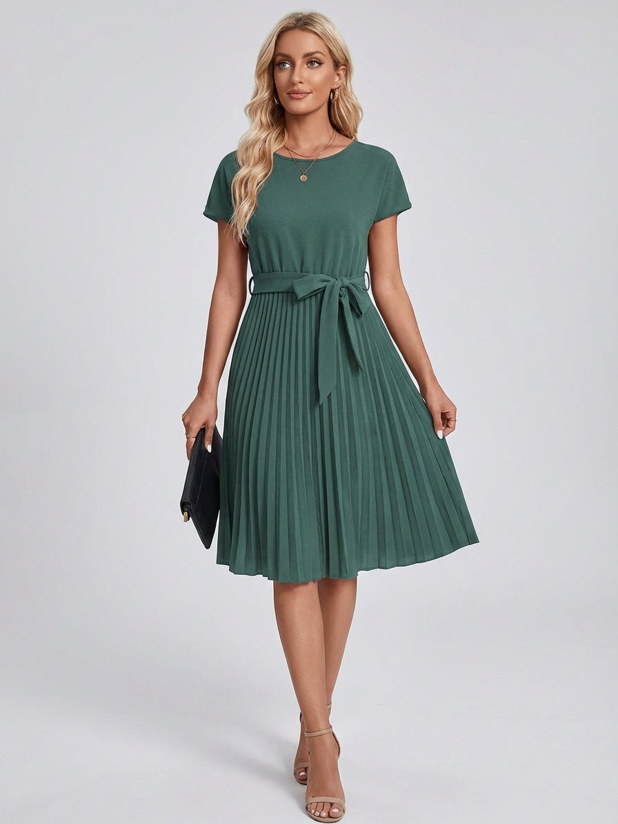 Army Green - A woman wearing a short-sleeve, crew-neck burgundy midi dress with a belted waist and a pleated accordion skirt, holding a black clutch.
