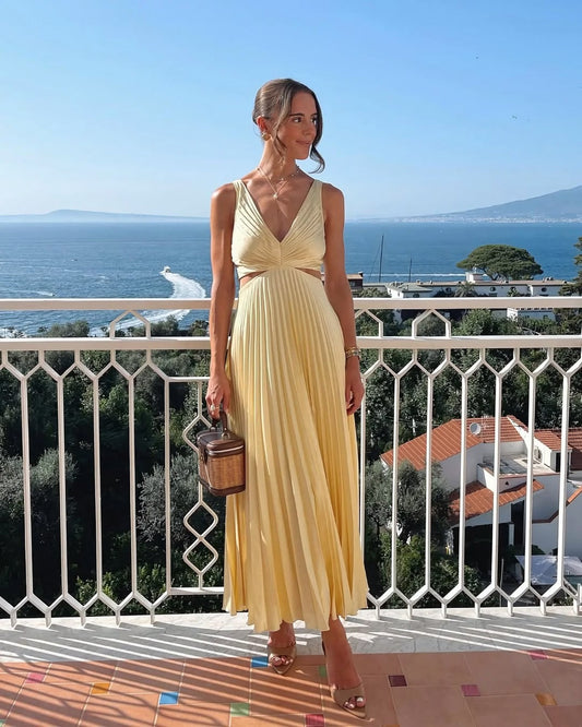 Yellow - Sleeveless pale yellow pleated maxi dress featuring a V-neckline, side waist cutouts, and a flowing accordion-pleated skirt.
