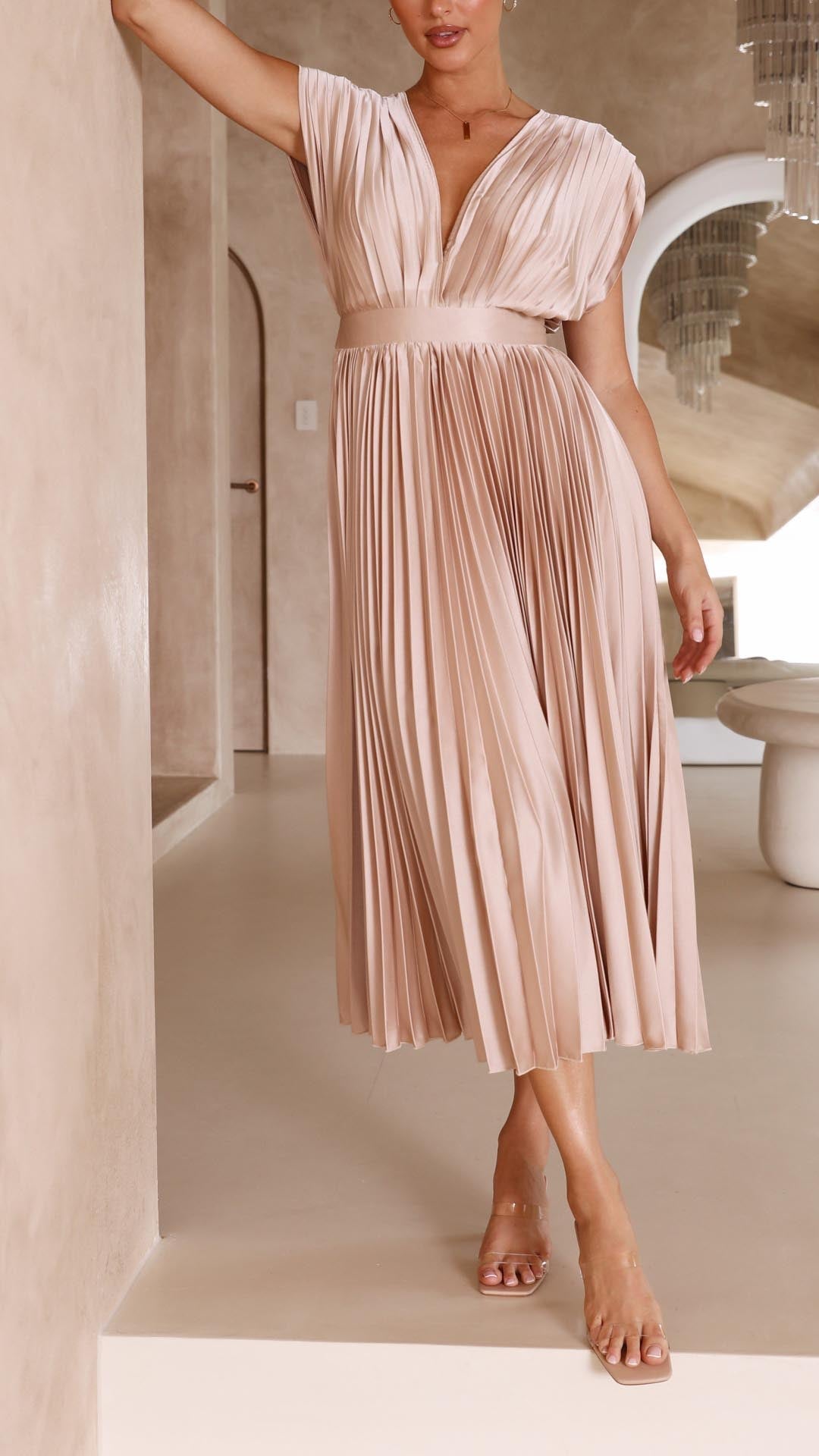 Pink - Champagne pleated midi dress featuring a plunging V-neckline, wide banded waist, and a fluid A-line skirt.