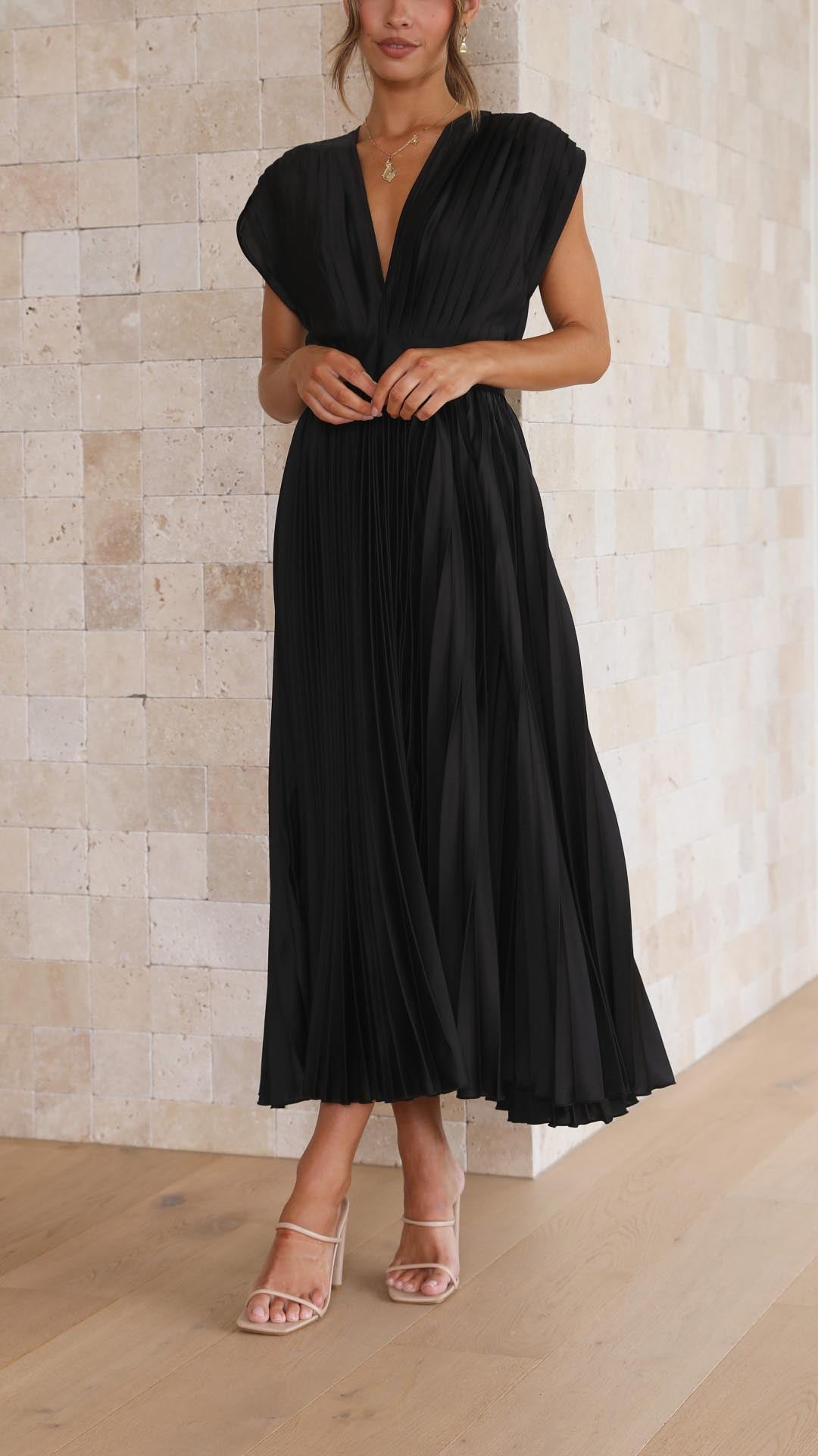 Black - Champagne pleated midi dress featuring a plunging V-neckline, wide banded waist, and a fluid A-line skirt.