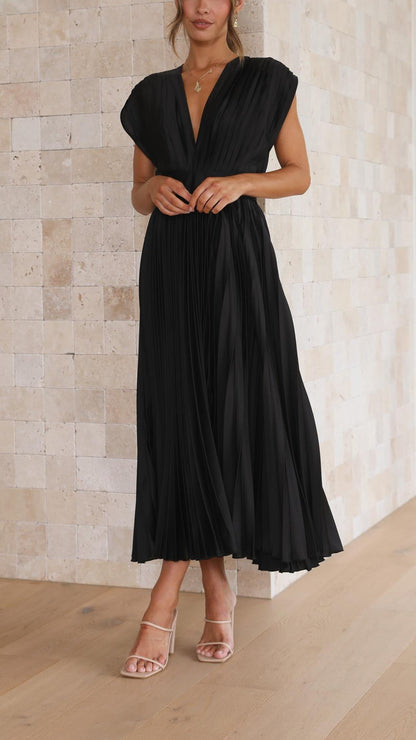 Black - Champagne pleated midi dress featuring a plunging V-neckline, wide banded waist, and a fluid A-line skirt.