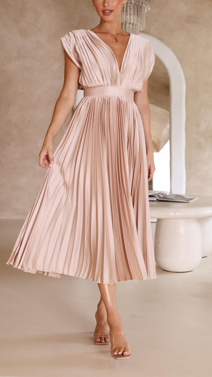 Antique Pink - Woman wearing a dusty rose pleated midi dress with a deep V-neckline and banded waist.