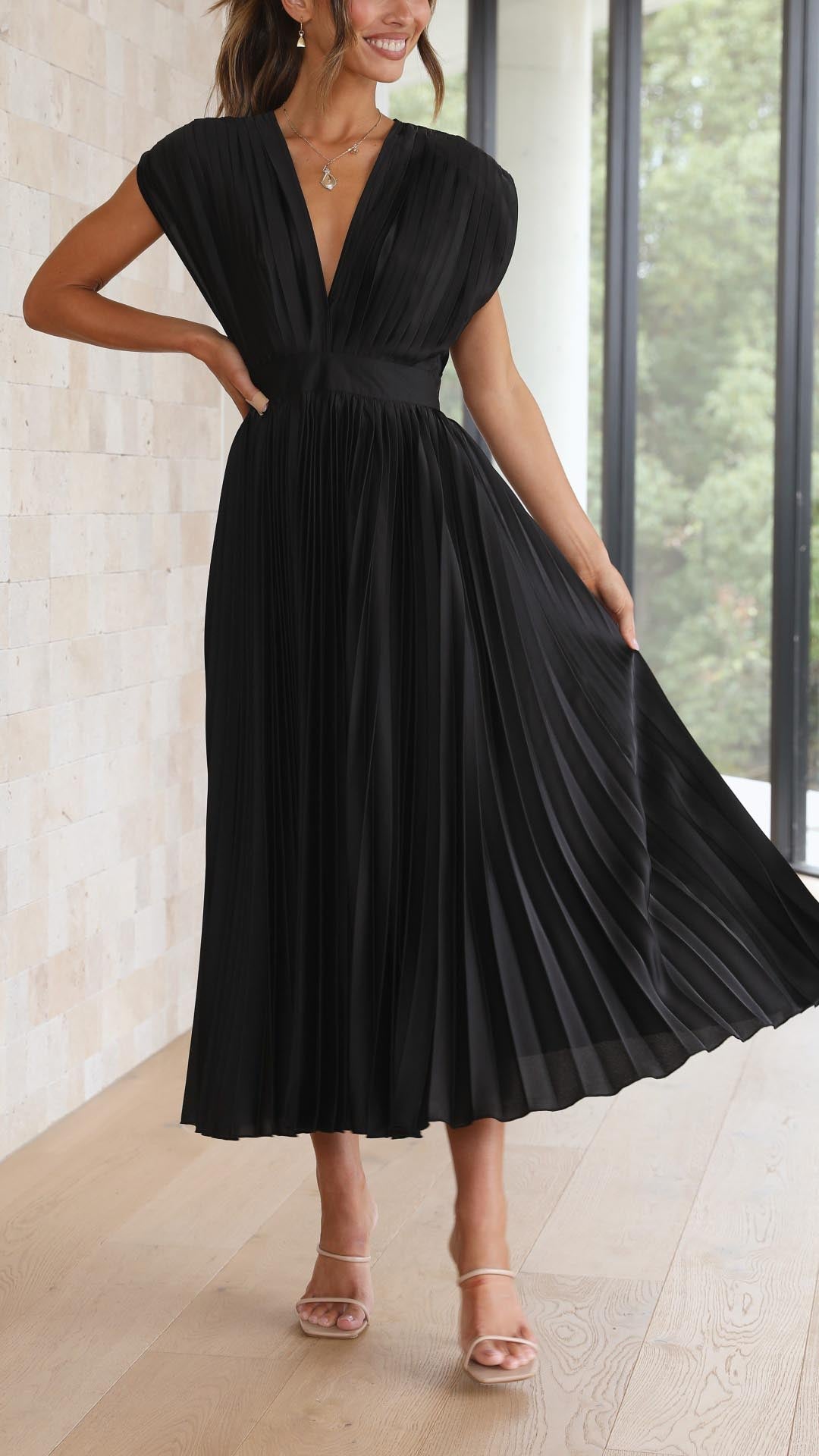 Antique Pink - Woman wearing a dusty rose pleated midi dress with a deep V-neckline and banded waist.