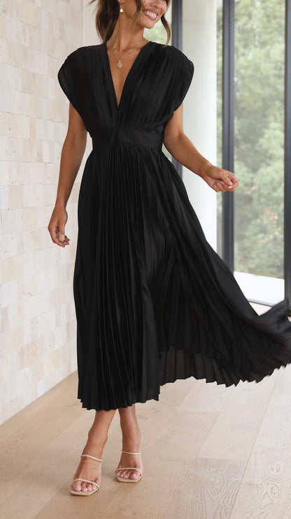 Black - Woman wearing a dusty rose pleated midi dress with a deep V-neckline and banded waist.