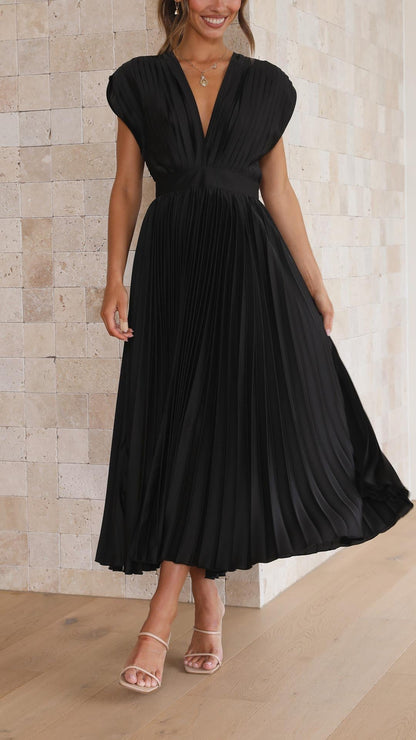 Black - Woman wearing a dusty rose pleated midi dress with a deep V-neckline and banded waist.