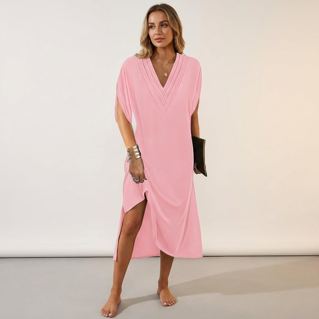 Pink - A woman wearing an olive green crepe shift dress with a pleated V-neckline, split short sleeves, and a relaxed silhouette.
