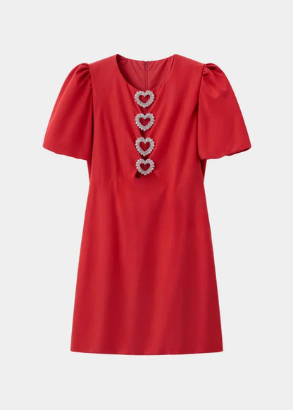 Red - Black mini dress with white polka dots, featuring short puff sleeves, a center front cutout, and three contrasting white 3D bows down the bodice.