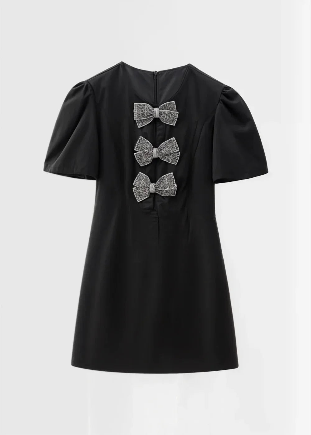 Black with pearls - Black mini dress with white polka dots, featuring short puff sleeves, a center front cutout, and three contrasting white 3D bows down the bodice.