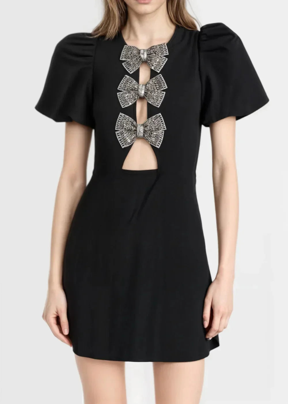 Black - Black mini dress with white polka dots, featuring short puff sleeves, a center front cutout, and three contrasting white 3D bows down the bodice.