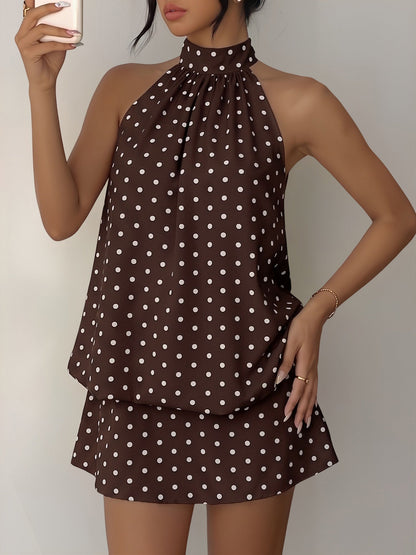 Coffee - Woman wearing a sleeveless polka dot halter mini dress with a tiered drape against a plain background