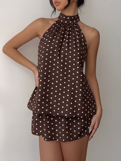 Coffee - Woman wearing a sleeveless polka dot halter mini dress with a tiered drape against a plain background