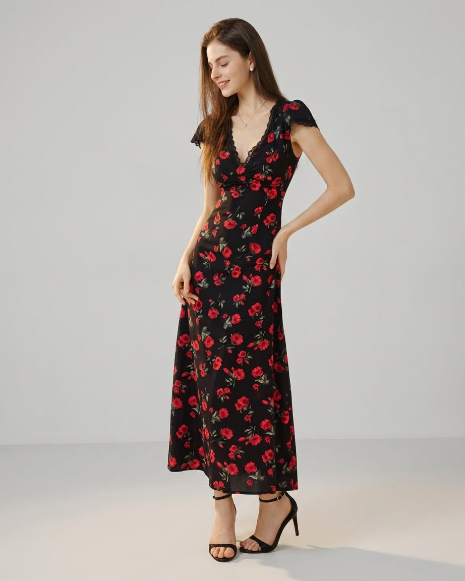 Black - A woman wearing a black midi-length dress with a red rose print, featuring a lace-trimmed V-neckline, cap sleeves, and a fluid A-line skirt.