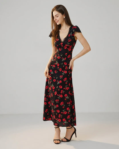 Black - A woman wearing a black midi-length dress with a red rose print, featuring a lace-trimmed V-neckline, cap sleeves, and a fluid A-line skirt.