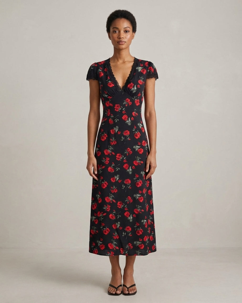 Black - A woman wearing a black midi-length dress with a red rose print, featuring a lace-trimmed V-neckline, cap sleeves, and a fluid A-line skirt.