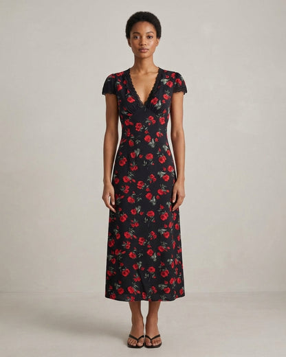 Black - A woman wearing a black midi-length dress with a red rose print, featuring a lace-trimmed V-neckline, cap sleeves, and a fluid A-line skirt.