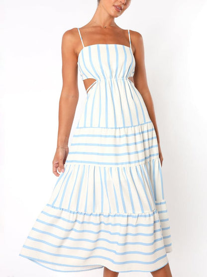 A woman wearing a light blue and white striped midi dress featuring a square neckline, thin spaghetti straps, side waist cutouts, and a tiered skirt with alternating stripe directions.