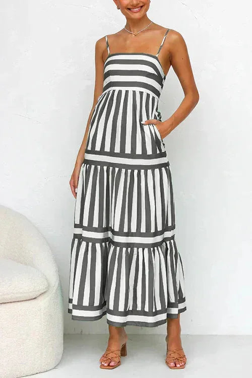 Women's striped midi dress featuring a square neckline, thin straps, side pockets, and a tiered skirt with contrasting horizontal and vertical stripe placement.