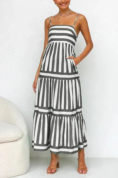 Women's striped midi dress featuring a square neckline, thin straps, side pockets, and a tiered skirt with contrasting horizontal and vertical stripe placement.