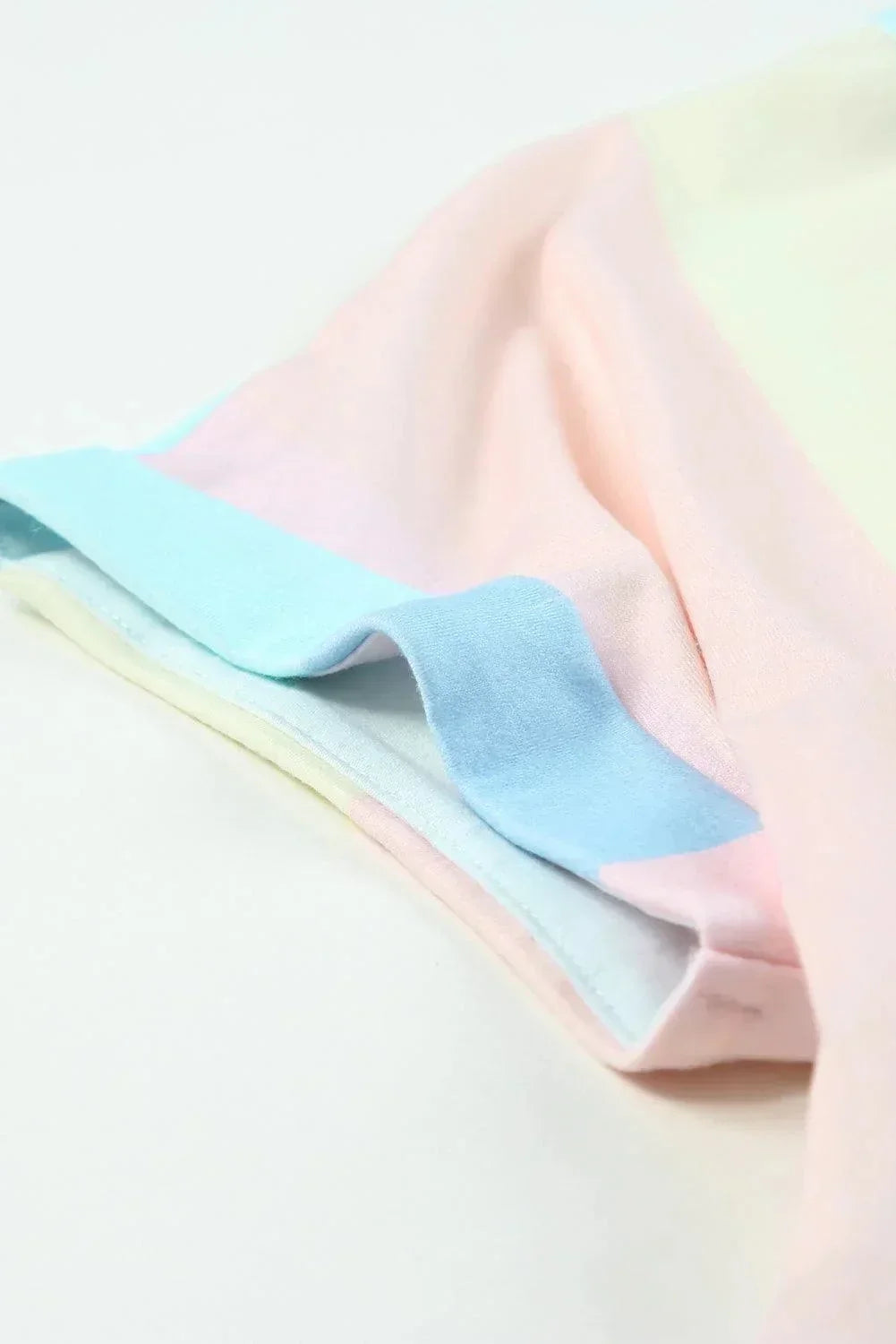 Pastel light - Women's pastel colorblock striped mini dress featuring a V-neckline, short rolled sleeves, and a gathered tiered hem.
