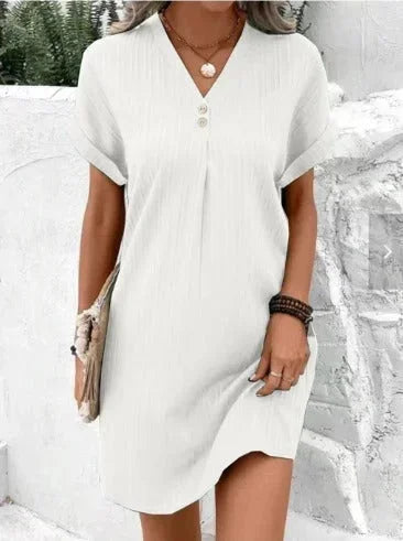 White - Forest green textured shift mini dress featuring a V-neckline, two-button placket, and cuffed short sleeves.