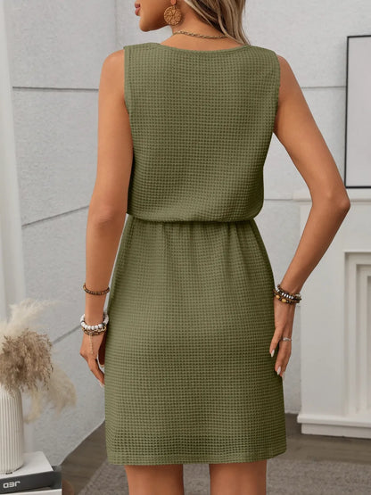 Green - Sleeveless textured knit mini dress featuring a scoop neckline and an adjustable drawstring waist.