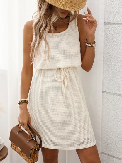 Navy - Sleeveless textured knit mini dress featuring a scoop neckline and an adjustable drawstring waist.
