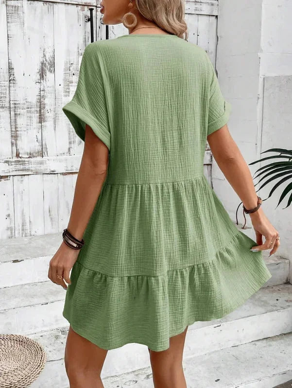 Green - Light beige textured linen mini dress featuring a V-neckline, cuffed short sleeves, and a tiered ruffled hem.