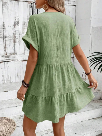 Green - Light beige textured linen mini dress featuring a V-neckline, cuffed short sleeves, and a tiered ruffled hem.