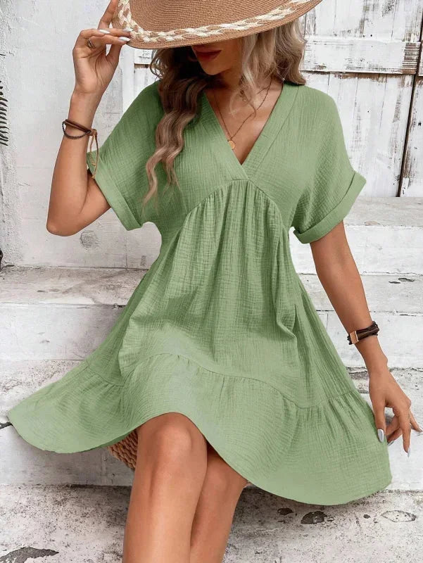 Green - Light beige textured linen mini dress featuring a V-neckline, cuffed short sleeves, and a tiered ruffled hem.