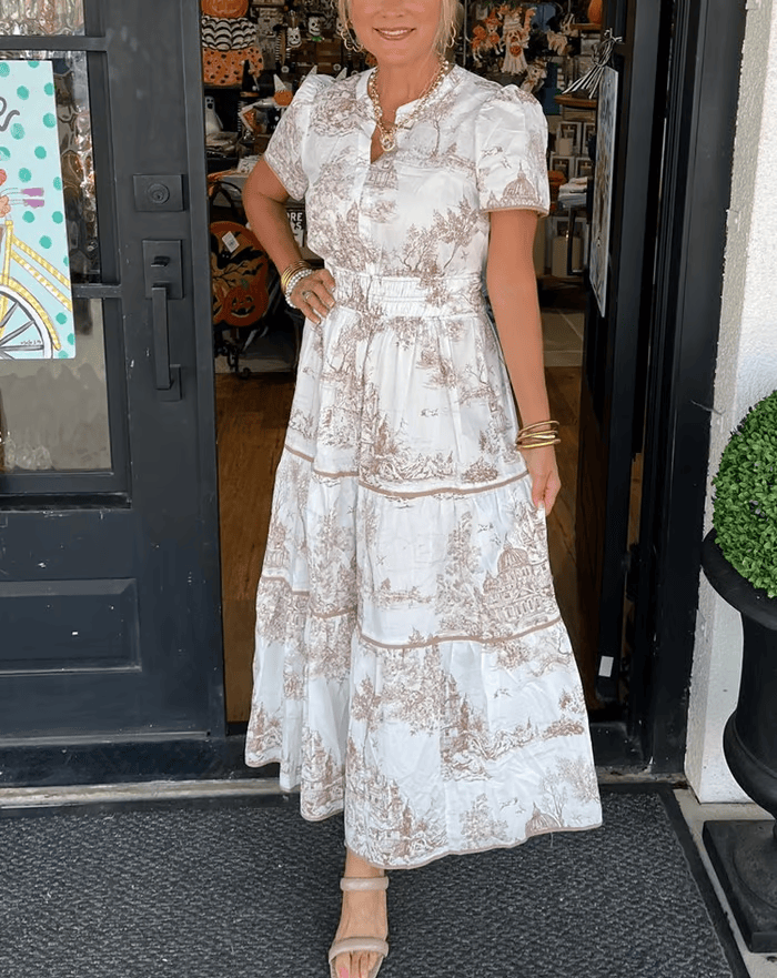 Khaki/Purple - A woman wearing a white and brown toile print cotton poplin maxi dress with puff sleeves, a smocked waist, and a tiered skirt.