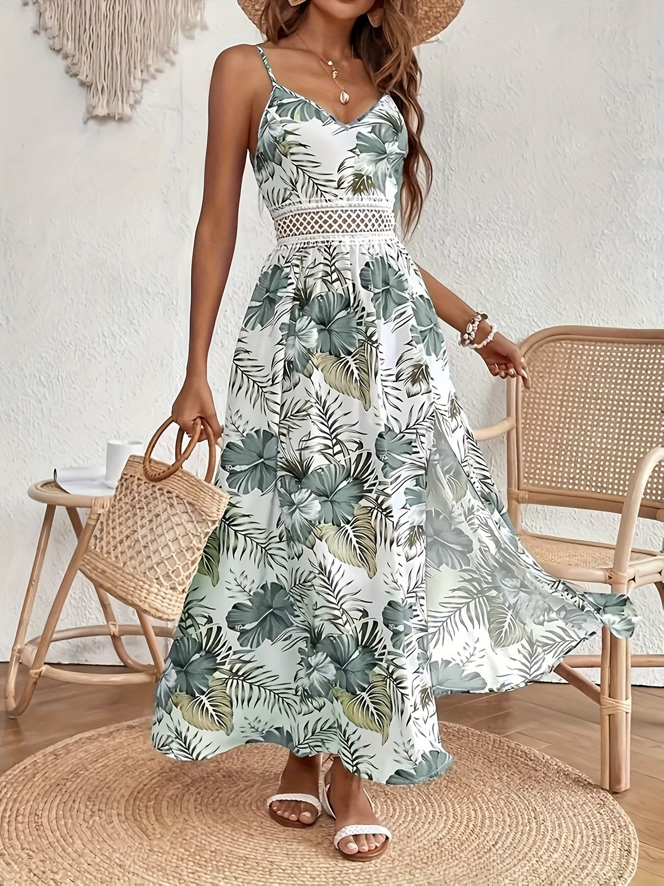 Green - Woman sitting in a white maxi dress with green tropical leaf print, featuring a crochet waist panel and high front slit.