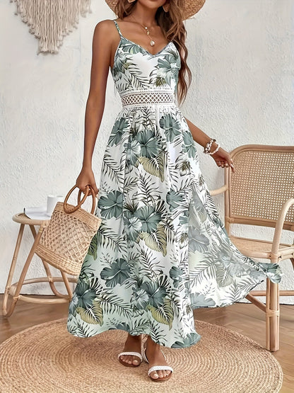 Green - Woman sitting in a white maxi dress with green tropical leaf print, featuring a crochet waist panel and high front slit.