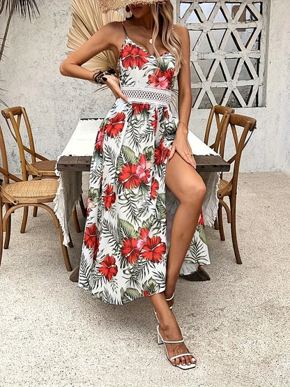 Red - Woman sitting in a white maxi dress with green tropical leaf print, featuring a crochet waist panel and high front slit.
