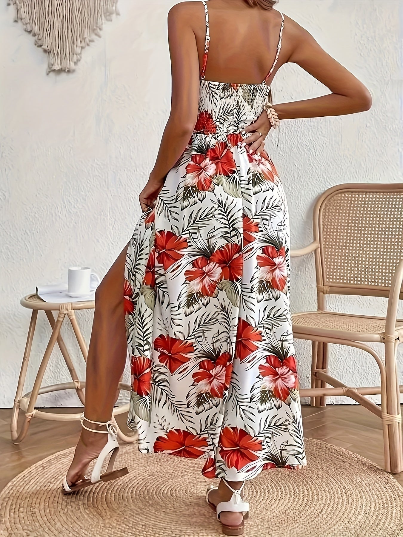 Red - Woman sitting in a white maxi dress with green tropical leaf print, featuring a crochet waist panel and high front slit.