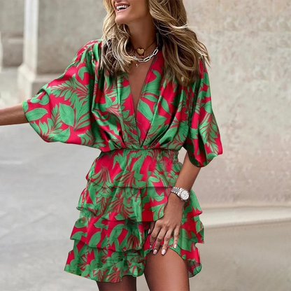 Green flower - Black and beige tropical leaf print mini dress featuring a deep V-neckline, wide sleeves, smocked waist, and tiered ruffle skirt.