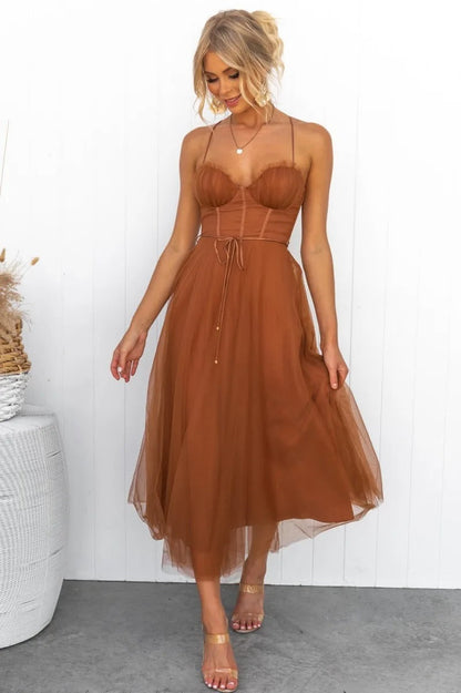 Brown - Rust brown tulle midi dress featuring a structured corset bodice with ruched cups, thin straps, a delicate waist tie, and a voluminous A-line skirt with a sheer hem.