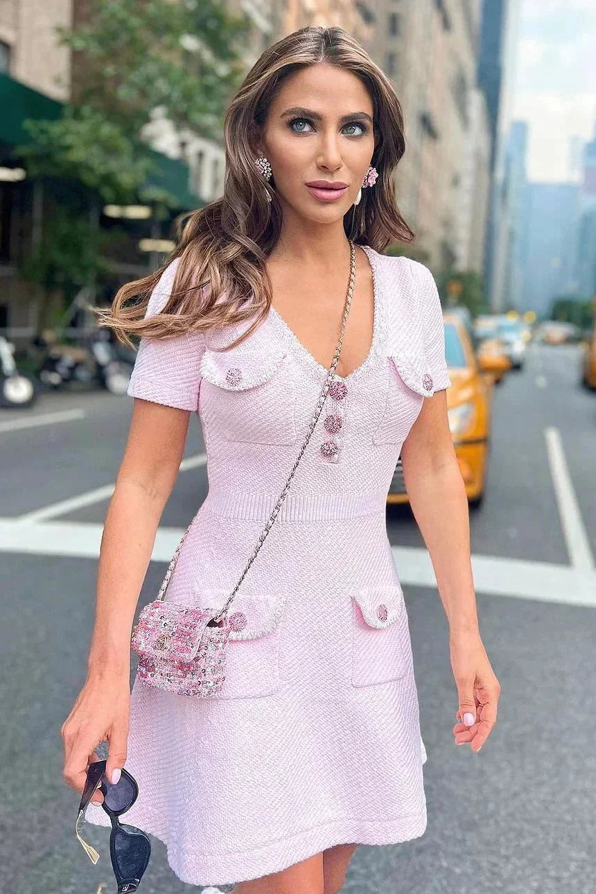 Pink - Light pink textured tweed short-sleeve mini dress featuring a V-neckline, button-front bodice, and four patch pockets with embellished buttons.